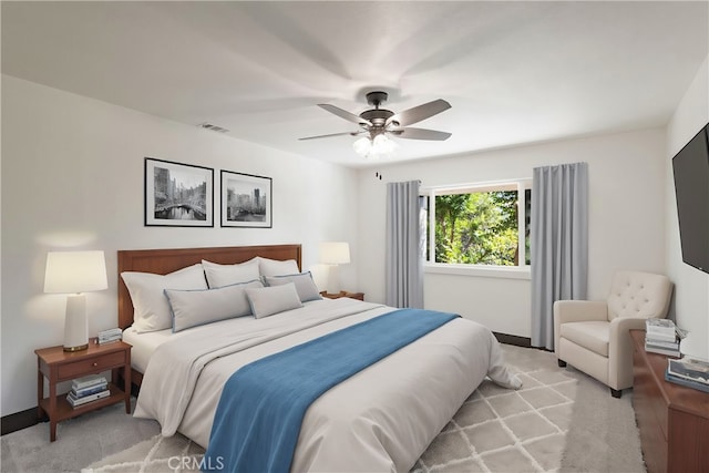 bedroom with ceiling fan and light colored carpet