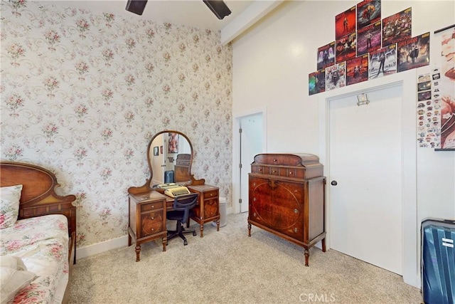 living area featuring beamed ceiling, ceiling fan, carpet flooring, and a high ceiling