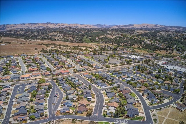 birds eye view of property featuring a mountain view