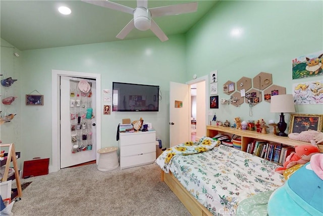 carpeted bedroom featuring ceiling fan and vaulted ceiling