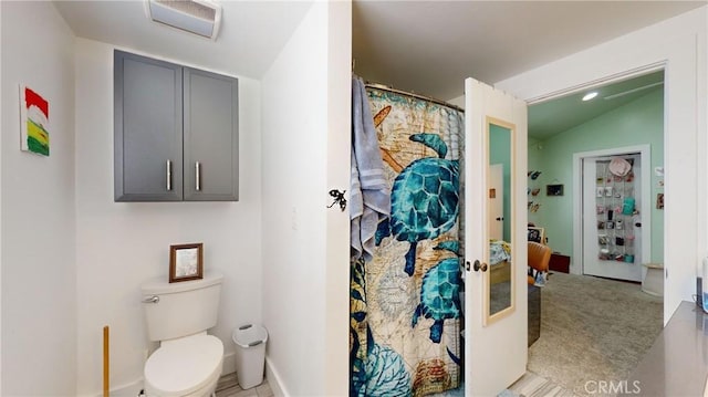 bathroom with vaulted ceiling and toilet