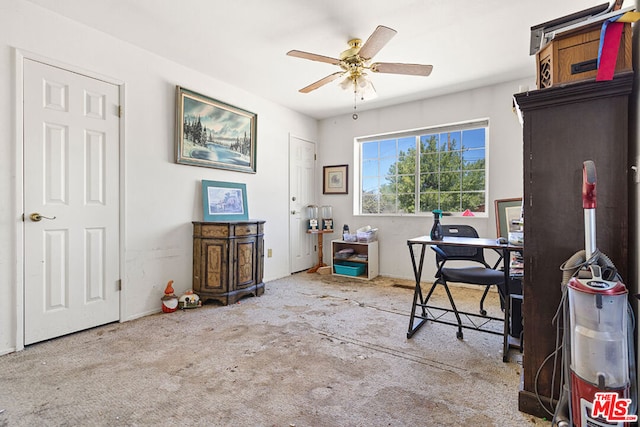 carpeted office featuring ceiling fan