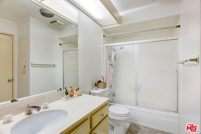 full bathroom with shower / bath combination with glass door, vanity, and toilet