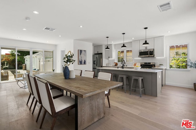 dining area featuring light hardwood / wood-style flooring and sink