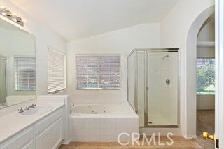 bathroom with vaulted ceiling, vanity, and separate shower and tub