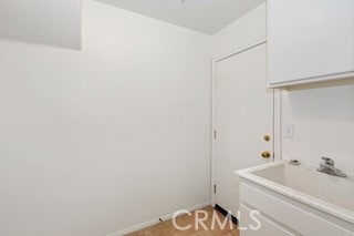 clothes washing area featuring sink