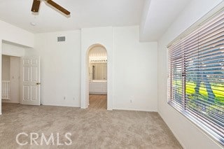 carpeted empty room featuring ceiling fan