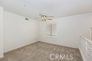 carpeted empty room with ceiling fan