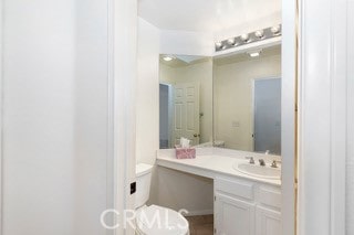 bathroom featuring vanity and toilet