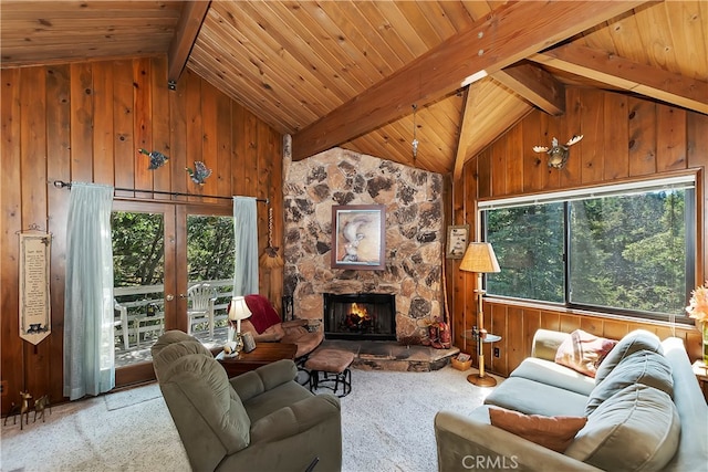 living room with wood walls, a fireplace, light carpet, vaulted ceiling with beams, and wooden ceiling