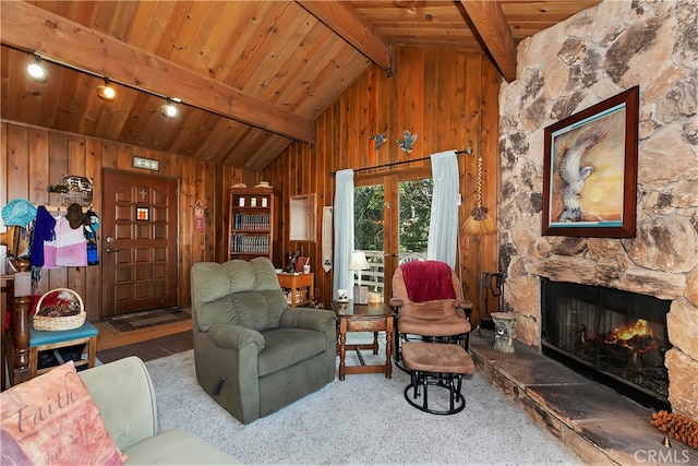 living room featuring wood ceiling, a fireplace, and lofted ceiling with beams