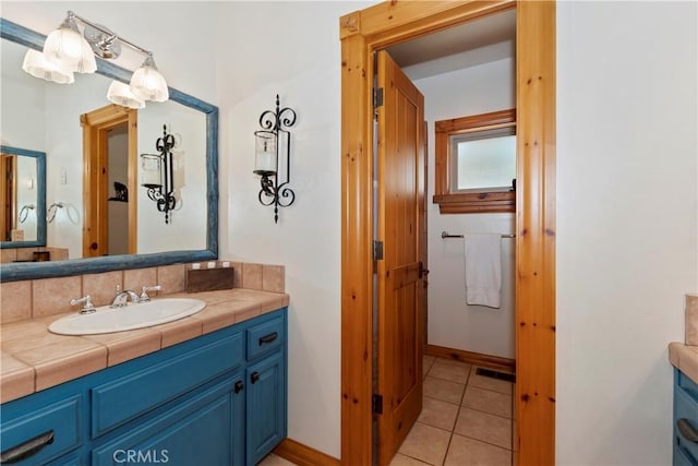 bathroom with tile patterned floors and vanity