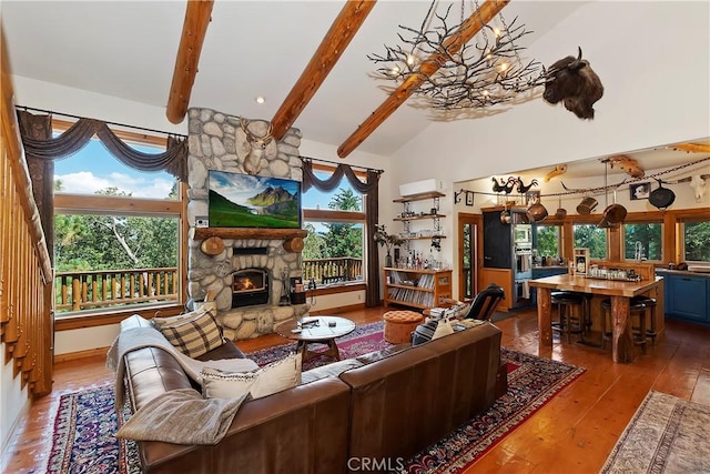 living room featuring a wealth of natural light, a fireplace, and hardwood / wood-style flooring