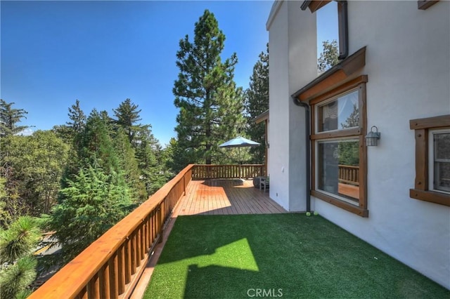 wooden terrace with a lawn