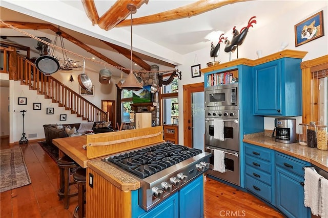 kitchen with hardwood / wood-style flooring, stainless steel appliances, blue cabinets, and vaulted ceiling with beams