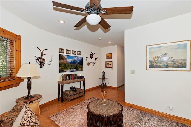 living room featuring ceiling fan and wood-type flooring