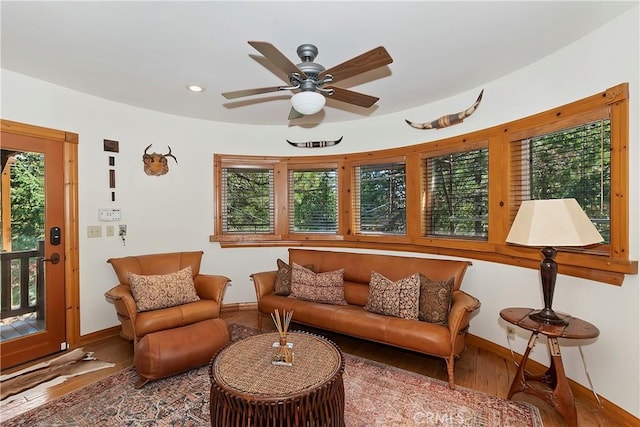 living area with ceiling fan and hardwood / wood-style flooring