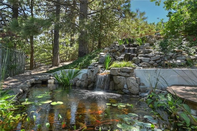 exterior space with a garden pond