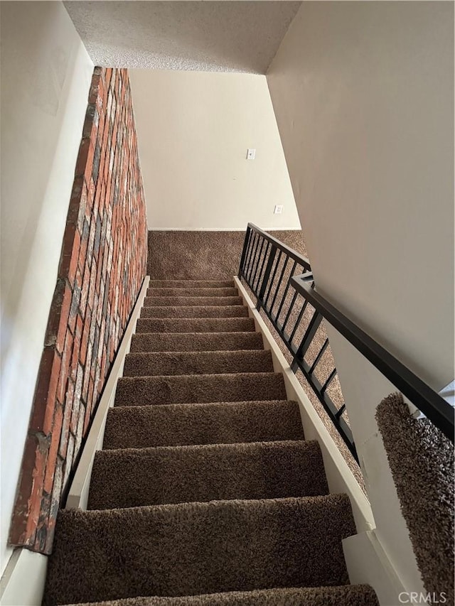 stairs featuring carpet flooring