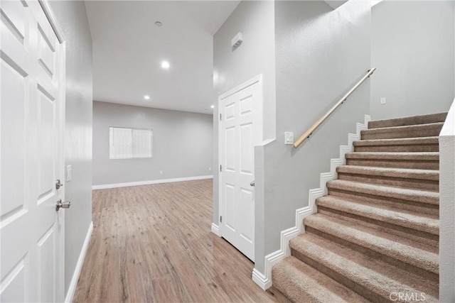 stairs featuring wood-type flooring