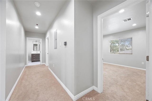 corridor with light colored carpet