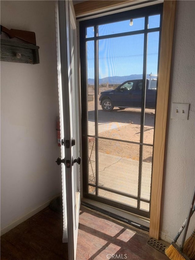 doorway to outside featuring a mountain view