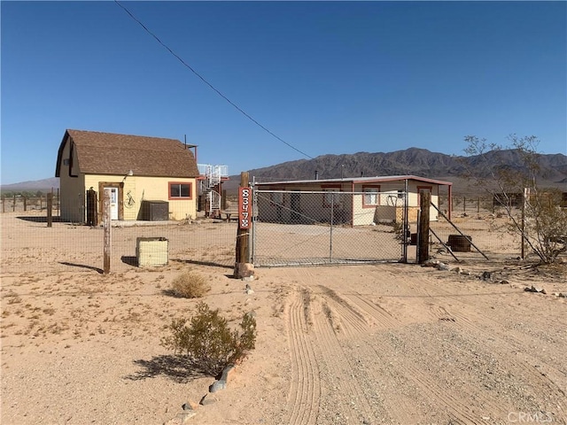 rear view of house with a mountain view and cooling unit