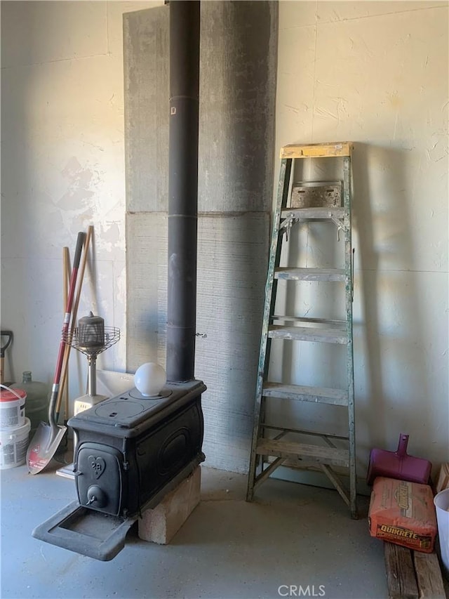 interior space with a wood stove and concrete flooring