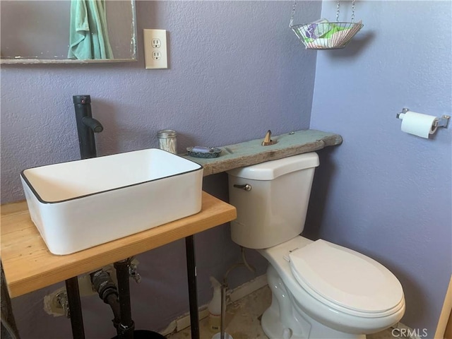 bathroom featuring sink and toilet