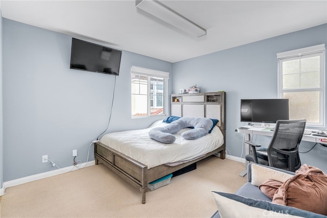 carpeted bedroom with baseboards