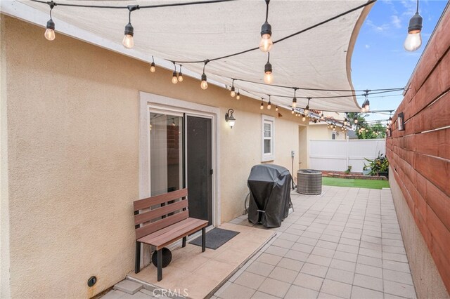 view of patio / terrace featuring a grill and fence