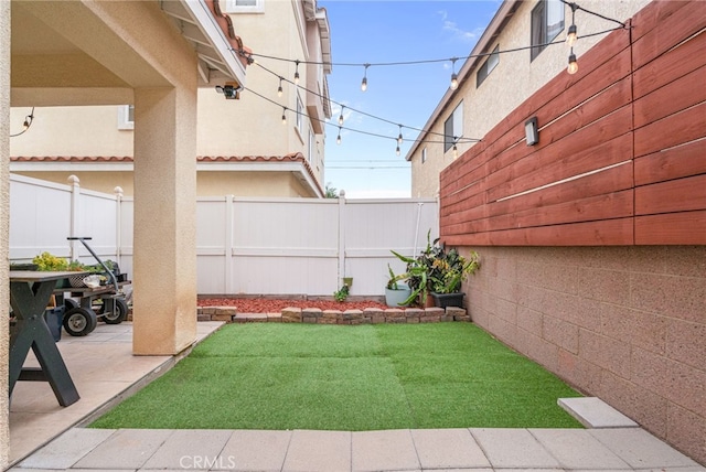 view of yard with fence and a patio