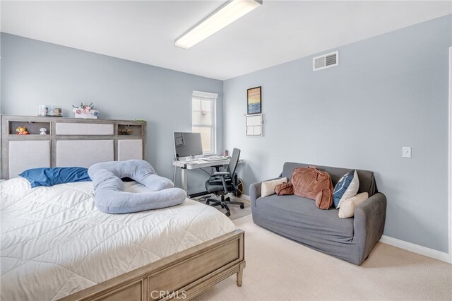 carpeted bedroom with baseboards and visible vents