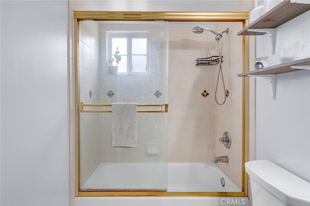 full bathroom with shower / bath combination with glass door and toilet