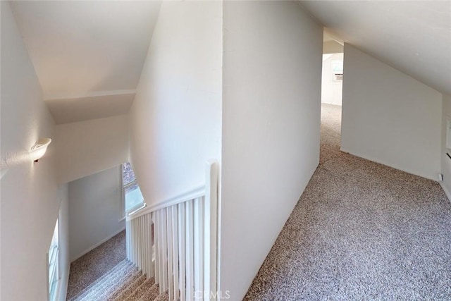 interior space featuring carpet flooring and vaulted ceiling