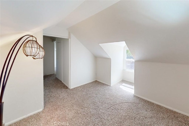 bonus room featuring light colored carpet and vaulted ceiling