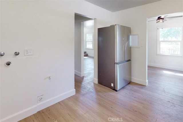 kitchen with light wood-type flooring, ceiling fan, and stainless steel refrigerator