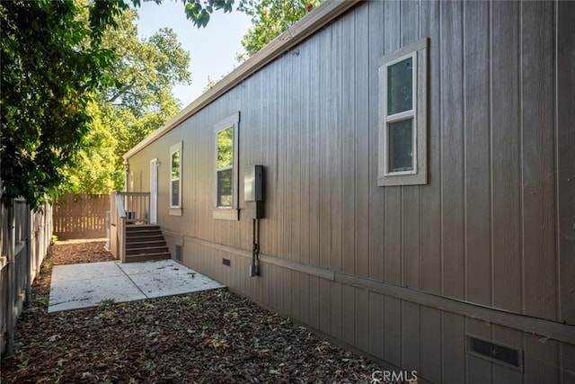 view of side of property with a patio area