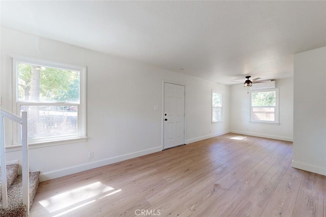 spare room featuring ceiling fan and light hardwood / wood-style floors