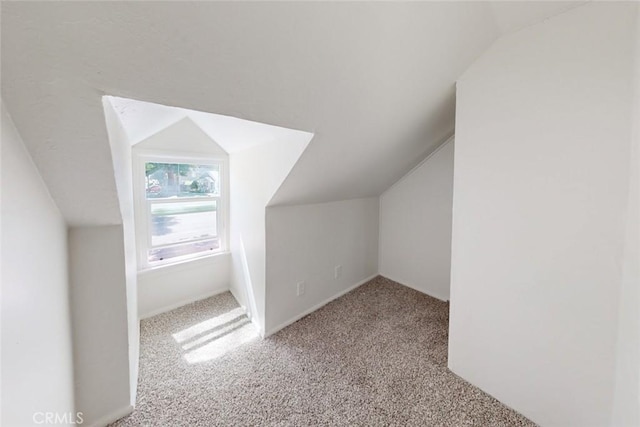 additional living space with light carpet and lofted ceiling