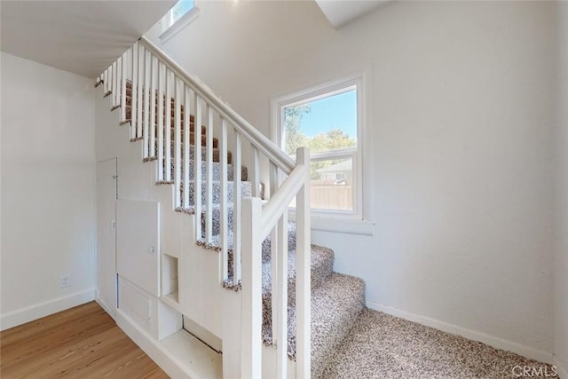 stairway with hardwood / wood-style flooring