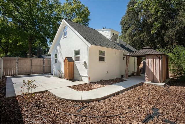 back of house featuring a gazebo and a patio