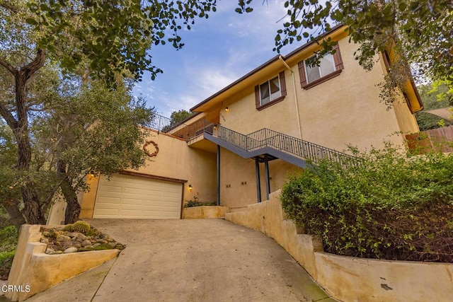 view of front of house featuring a balcony and a garage