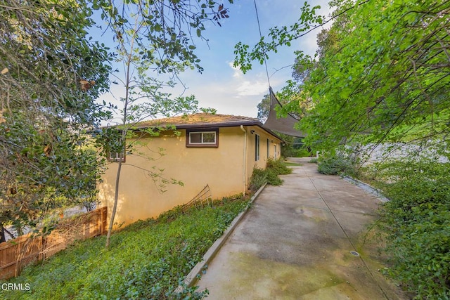 view of side of property with a patio area