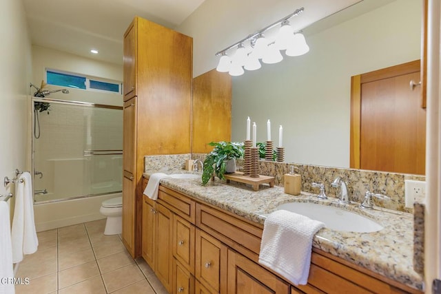 full bathroom featuring toilet, vanity, tile patterned floors, and shower / bath combination with glass door