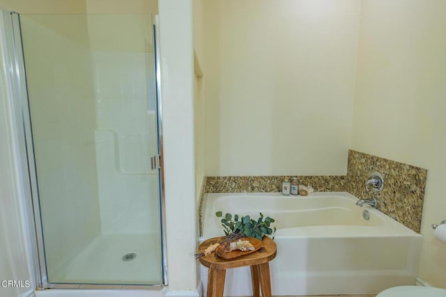 bathroom with shower with separate bathtub