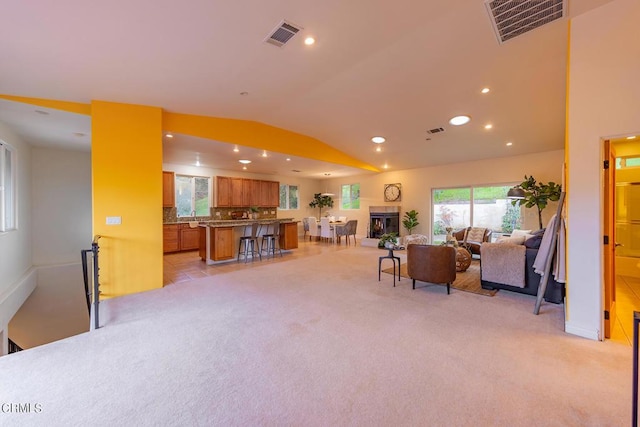 carpeted living room with vaulted ceiling