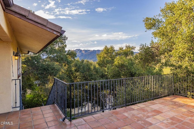 balcony featuring a mountain view and a patio