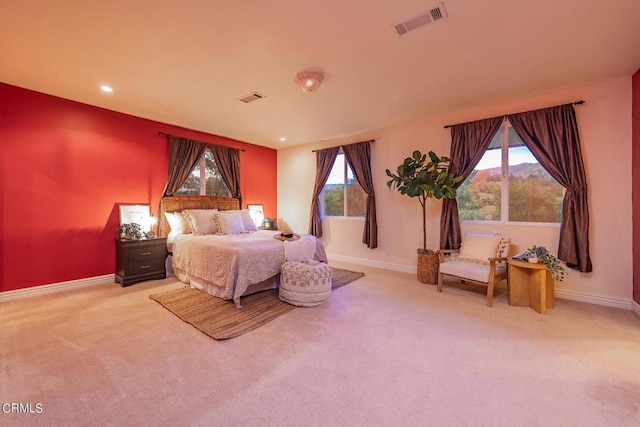 carpeted bedroom featuring multiple windows