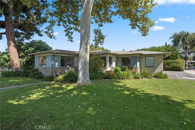 613 E Chapman Ave, Fullerton, CA 92831 - view of front of home featuring a front lawn, stone siding, and uncovered parking